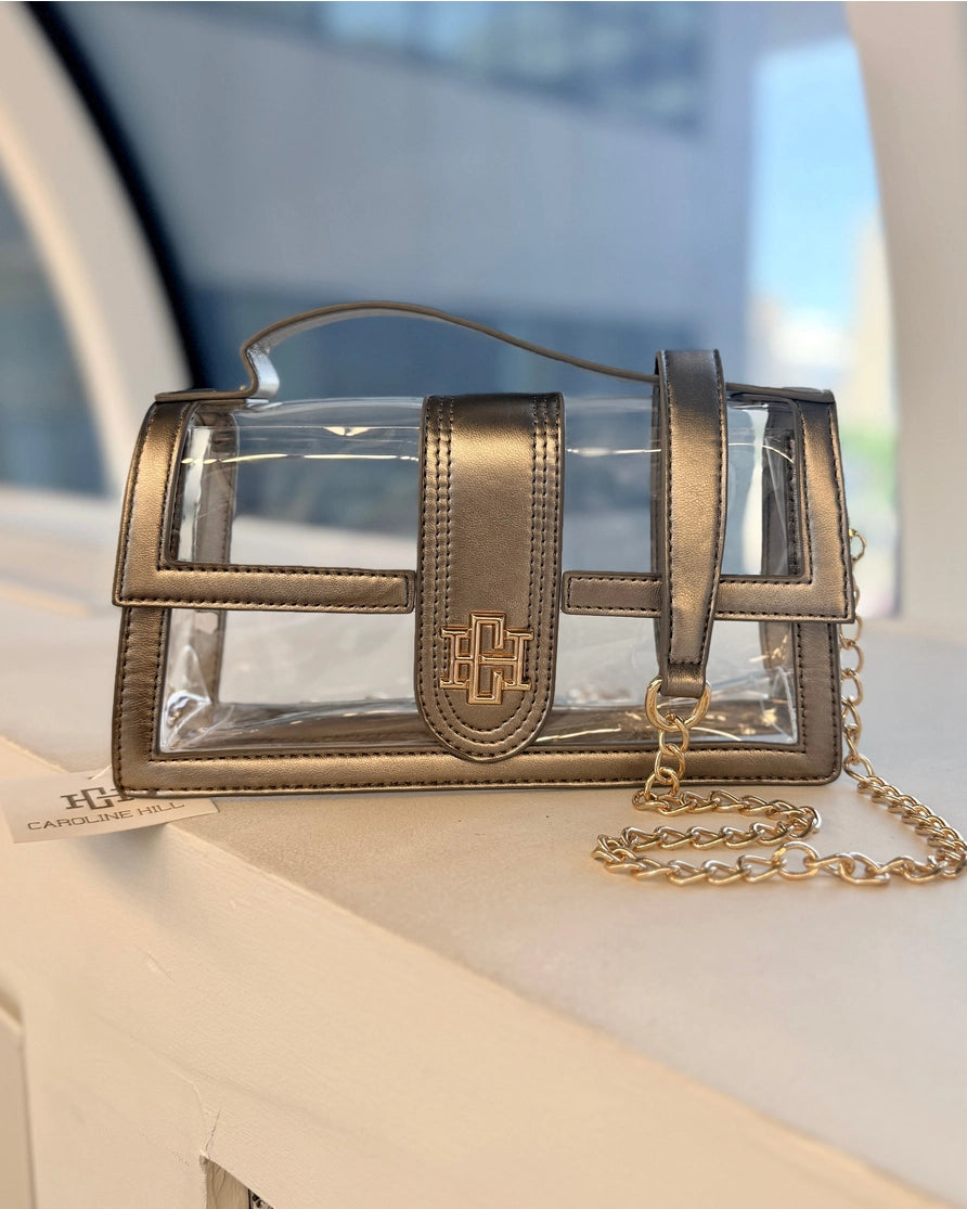Grace Dorada – bolsa transparente con detalles dorado bronce y cadena dorada