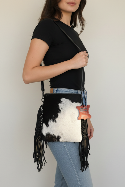 Black and White Cowhide Crossbody Bag with Fringe — full product shot showing cowhide hair texture